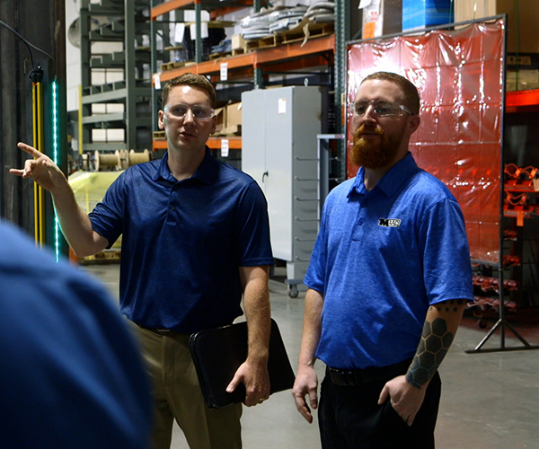 Standard Electric team working with a customer in an industrial facility