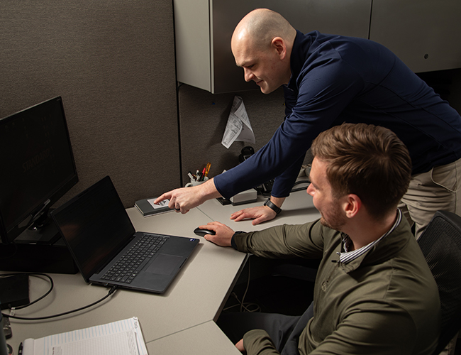 Technical specialists reviewing industrial electrical and automation systems